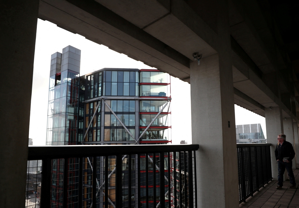 Visitor looks out from the Viewing Level towards a luxury block of flats from the Tate Modern gallery in London, Britain, February 12, 2020. REUTERS/Hannah McKay/File Photo