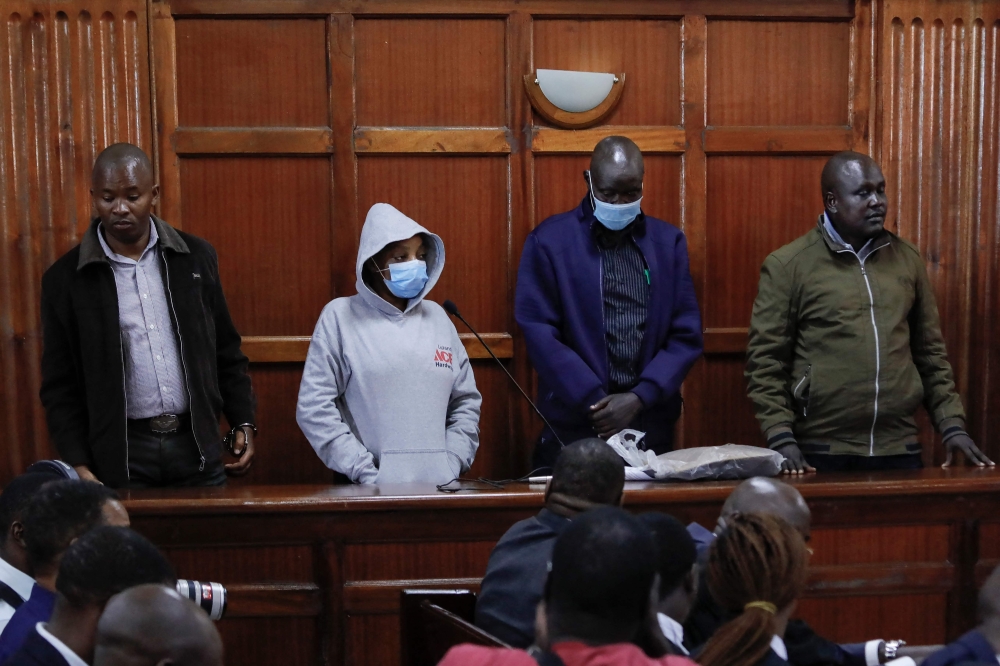 Former police officers and primary suspects in the murder of rights lawyer Willie Kimani and two others in 2016, Sergeant Fredlick ole Leliman (R) and his fellow officers Stephen Cheburet (2R), Sylvia Wanjiku (2L) along with a police informant, Peter Ngugi (L) stand in the dock during their sentencing in the Kenyan capital, Nairobi on February 3, 2023. (Photo by Tony KARUMBA / AFP)