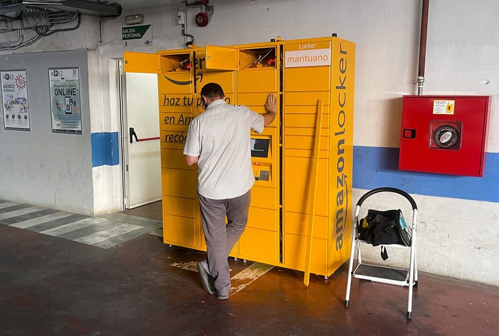 FILE PHOTO: A worker installs a new Amazon locker inside a public parking in Ronda, Spain, June 7, 2022. REUTERS/Jon Nazca