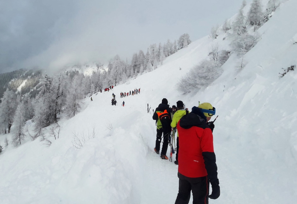 A photo taken on February 4, 2023 shows rescuers during their mission on a slope near Pill, western Austria. - Avalanches in Austria and Switzerland have left five people dead, leading officials to warn on February 4 of the risks posed by particularly unstable snow cover. Three of those killed were visiting Austria's Alpine regions. (Photo by ZOOM.TIROL / APA / AFP) 