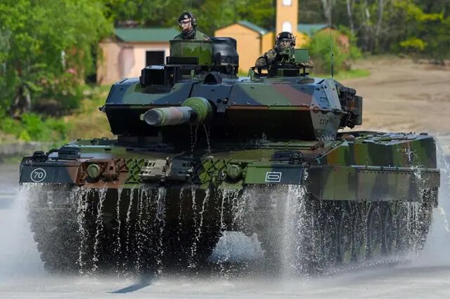 This file photo taken on May 20, 2019 shows soldiers on a Leopard 2 A7 main battle tank of the German armed forces Bundeswehr driving during an educational practice of the 
