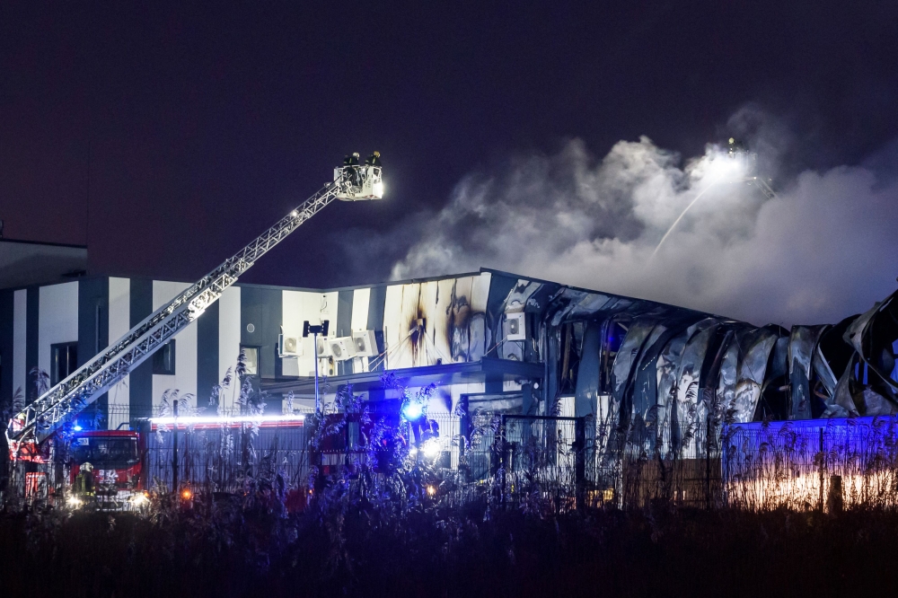 Firefighters extinguish a fire at a drone factory run by US firm Edge Autonomy in Marupe on the outskirts of Latvia's capital Riga on February 7, 2023. (Photo by Gints Ivuskans / AFP)