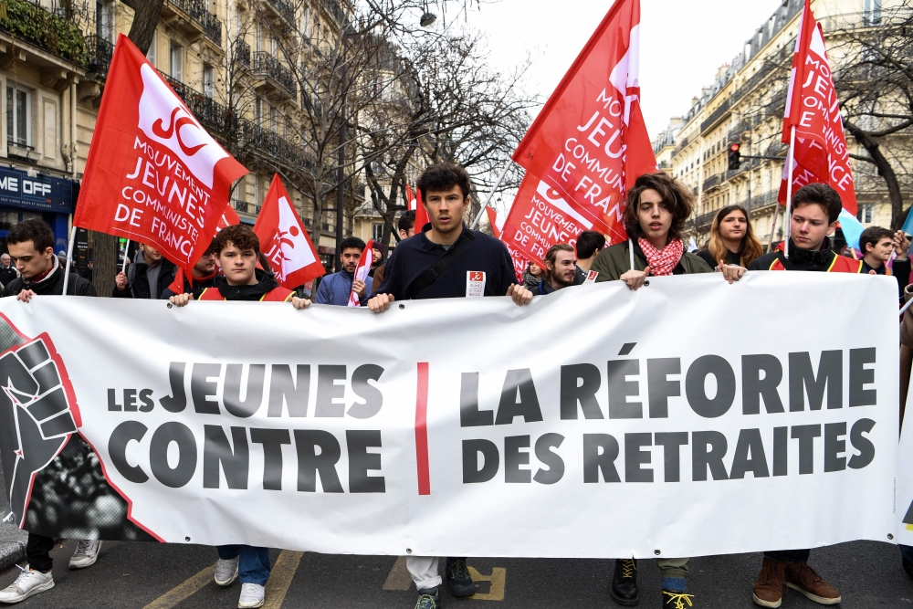 Protestors hold a banner reading 