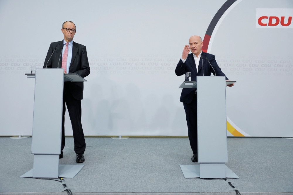 Christian Democratic Union (CDU) party's top candidate Kai Wegner (R) speaks during a joint press conference with leader of Germany's conservative Christian Democratic Union (CDU) party Friedrich Merz in the Konrad-Adenauer-Haus, headquarters for the CDU, in Berlin on February 13, 2023, one day after the repeat Berlin state elections. (Photo by Odd ANDERSEN / AFP)