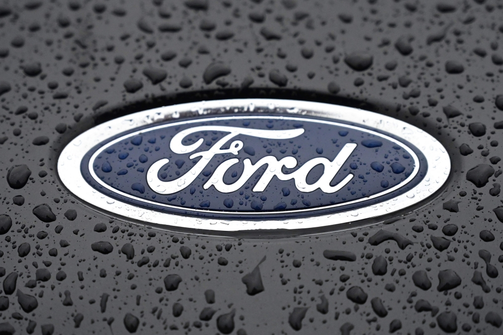 This file photograph taken on October 18, 2021, shows the Ford logo on the front of a vehicle at the company's Halewood plant in Liverpool, north-west England. - US automaker Ford said February 14, 2023, that it would cut 3,800 jobs in Europe, mostly in Britain and Germany, as competition in the electric car sector intensifies. Photo by Paul ELLIS / AFP