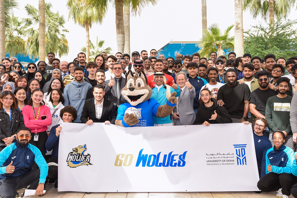 UDST President, Dr. Salem Al Naemi, faculty, staff and students during the unveiling of the new university mascot and logo – an Arabian Wolf. 
