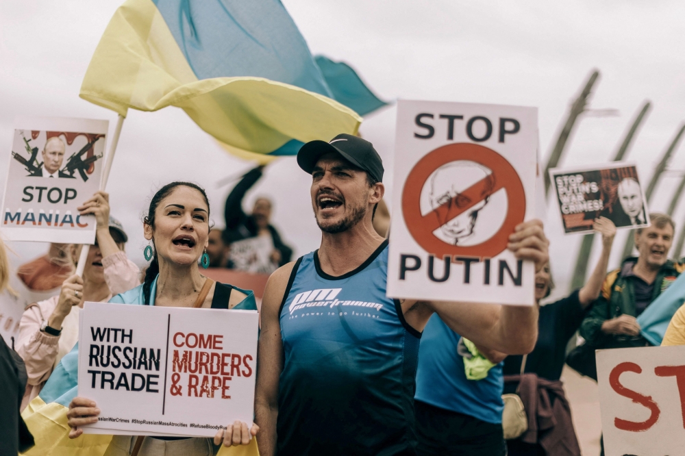 Protesters from Ukrainian Association of SA and civil society activists take part in a demonstration at the Umhlanga beach in Durban on February 18, 2023, against South Africa's joint military exercise with Russia and China along its eastern coast city of Richards Bay. (Photo by RAJESH JANTILAL / AFP)