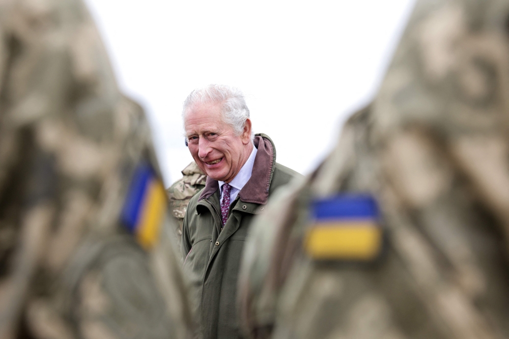 Britain's King Charles III attends a site in Wiltshire where Ukrainian recruits are being trained by British and international partner forces in south-west England on February 20, 2023. (Photo by Chris Jackson / AFP)