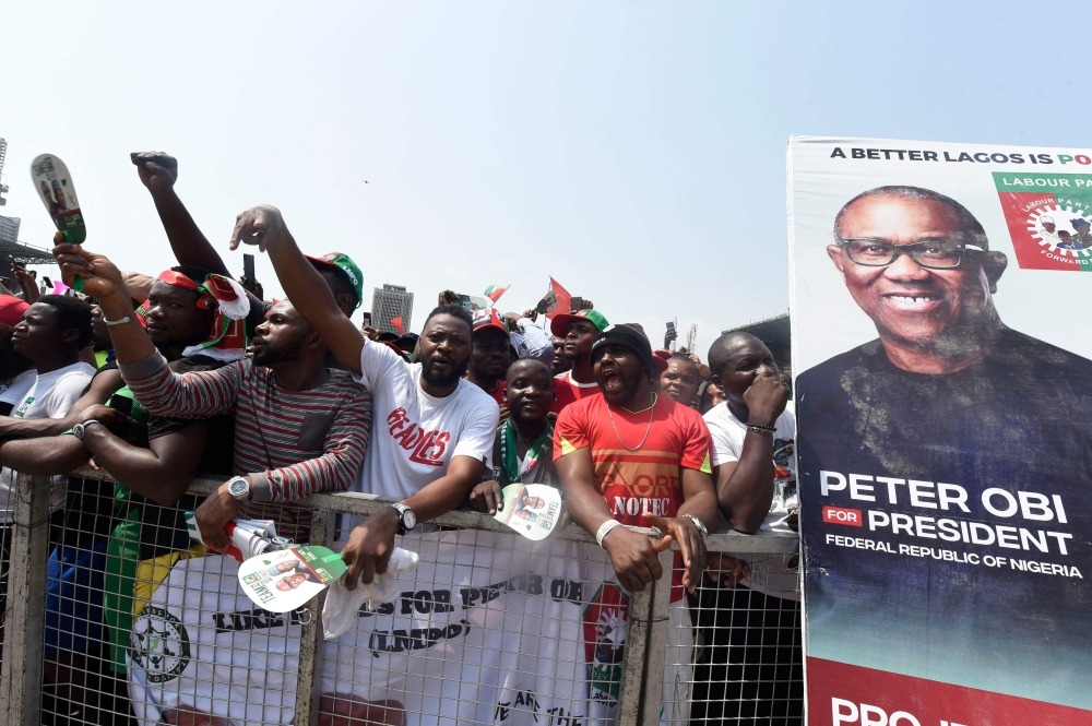 Supporters chant party slogans next to a banner of the candidate of the Labour Party Peter Obi during a campaign rally of the party in Lagos, on February 11, 2023. (Photo by PIUS UTOMI EKPEI / AFP)