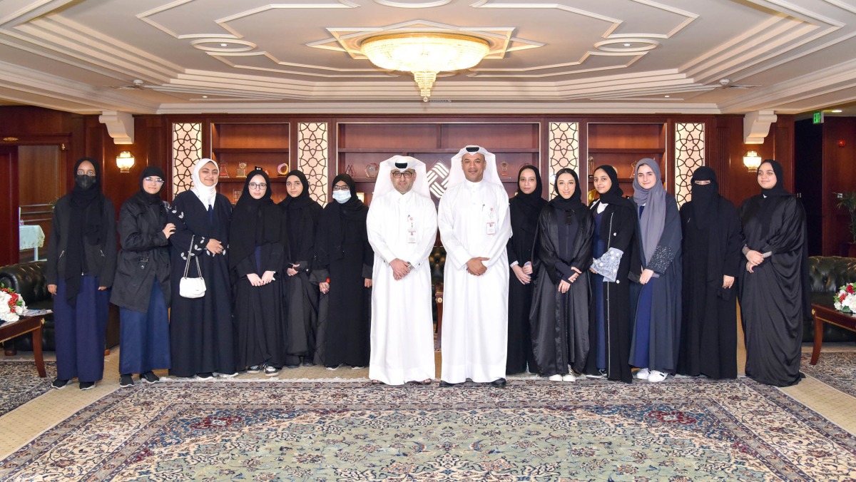 Students from Arwa Bint Abdul Muttalib Independent Secondary School for Girls with QIIB officials during the event held recently.