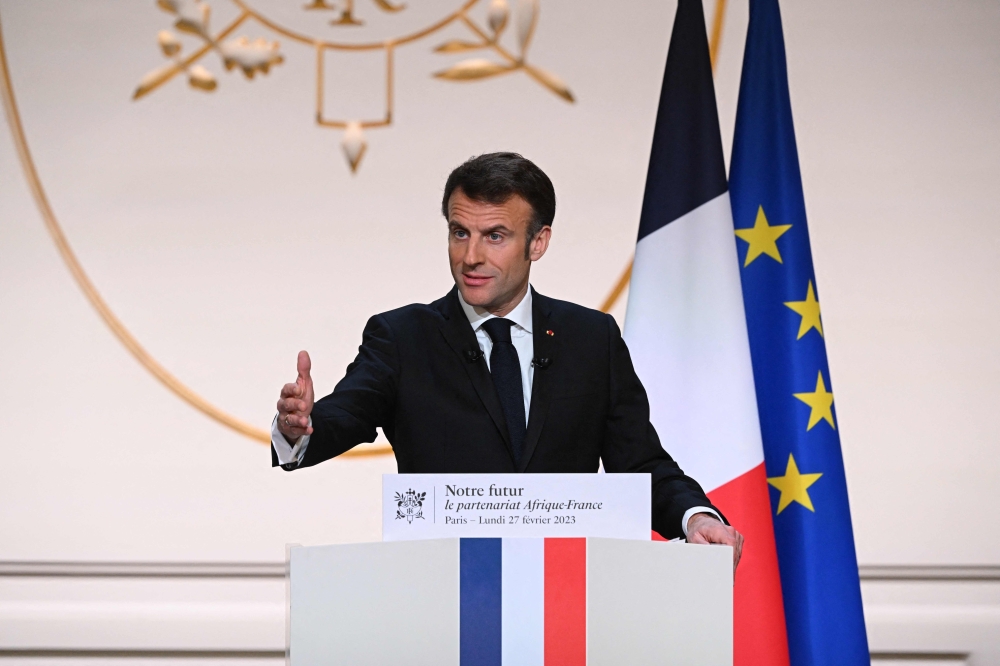 French President Emmanuel Macron gestures as he gives a speech to outline France's revamped strategy for Africa ahead of his visit in Central Africa, at the Elysee Palace in Paris on February 27, 2023.  (Photo by Stefano Rellandini / POOL / AFP)
