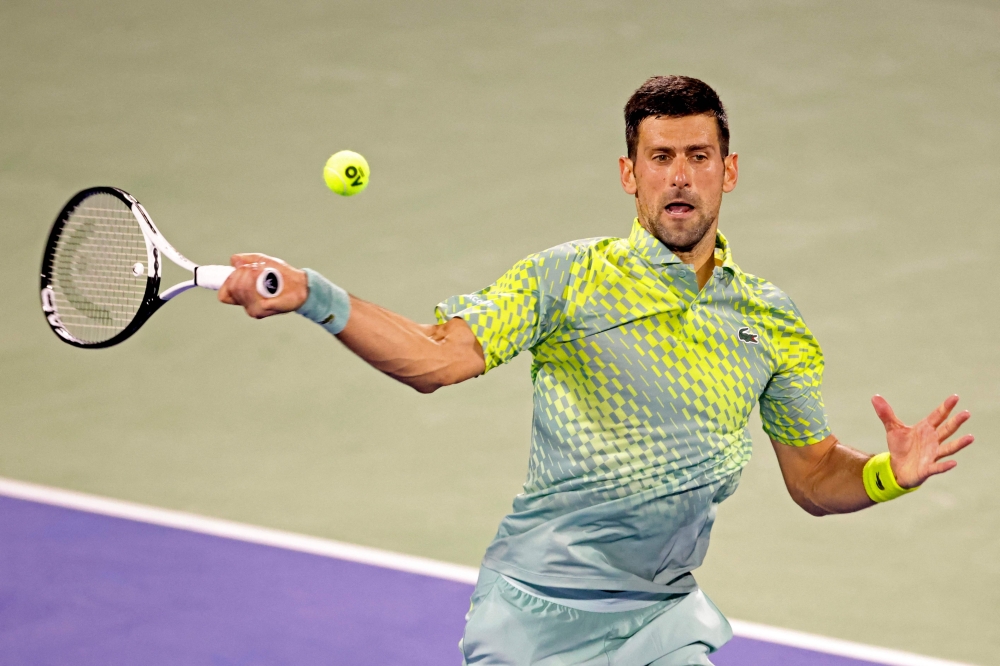 Serbia's Novak Djokovic hits a return against Netherlands' Tallon Griekspoor during their Dubai Duty Free Tennis Championship match in Dubai on March 1, 2023. (Photo by Karim SAHIB / AFP)