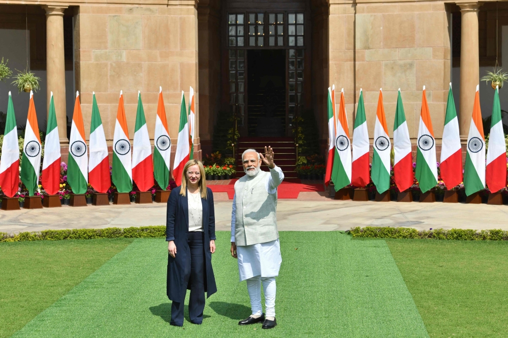 India's Prime Minister Narendra Modi and his Italian counterpart Giorgia Meloni pose before their meeting at the Hyderabad House in New Delhi on March 2, 2023. - Meloni said on March 2 she hoped India would use its G20 presidency to broker an end to the Ukraine war after unveiling a new strategic partnership with New Delhi. (Photo by AFP)
