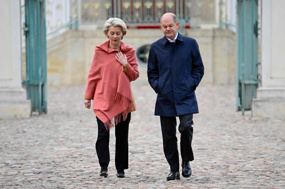 German Chancellor Olaf Scholz (right) and European Commission President Ursula von der Leyen make their way to a news conference at the federal cabinet retreat at Schloss Meseberg palace in Meseberg near Gransee, northeastern Germany on March 5, 2023. (Photo by Tobias SCHWARZ / AFP)