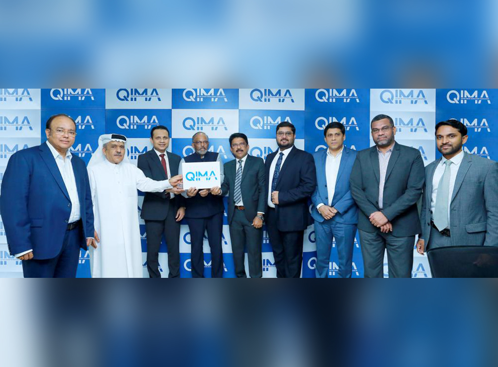 QIMA officials displaying the new logo.