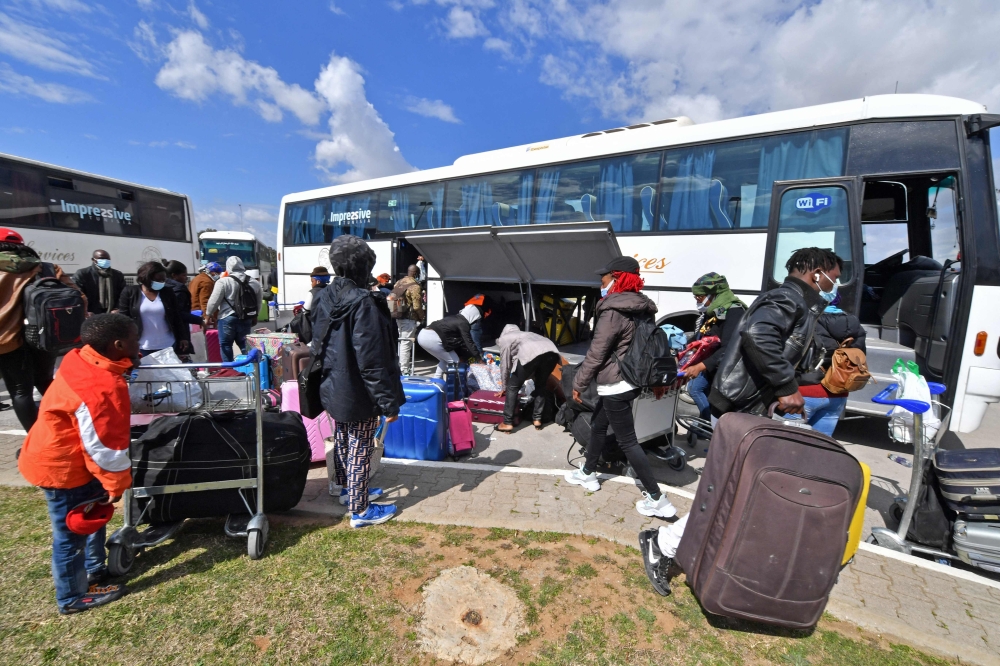 Migrants arrive at Tunis-Carthage International airport on March 7, 2023 as they prepare to leave Tunis on a repatriation flight.  (Photo by FETHI BELAID / AFP)