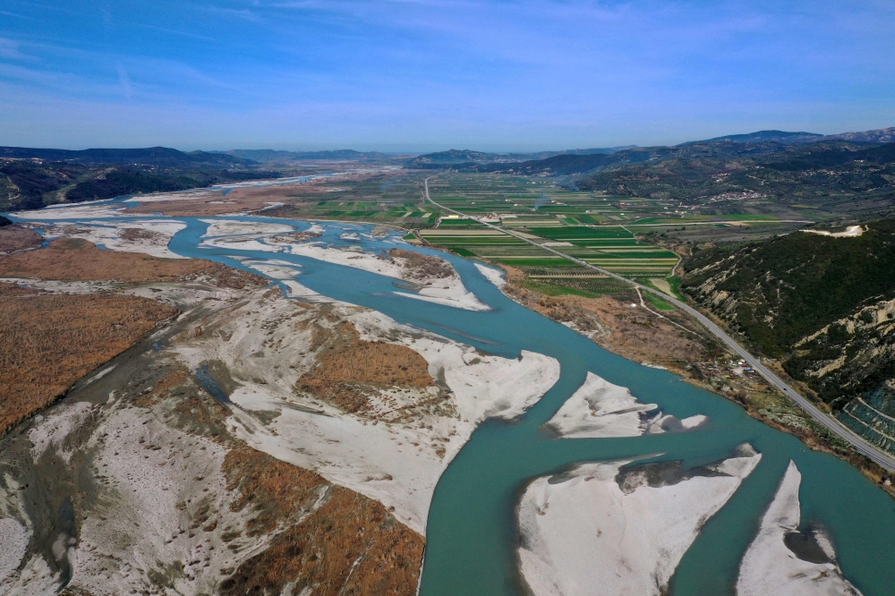 An aerial view taken on March 14, 2023, shows Vjosa, one of the last wild rivers in Europe, at her natural flow, near the city of Fier. (Photo by ADNAN BECI / AFP)

