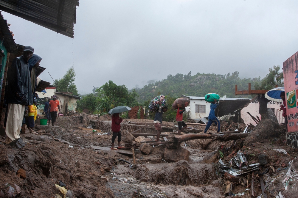 People repatriate residents and their property from a flood affected Chimwankhunda location in Blantyre on March 14, 2023 following heavy rains caused by cyclone Freddy. (Photo by Amos Gumulira / AFP)
