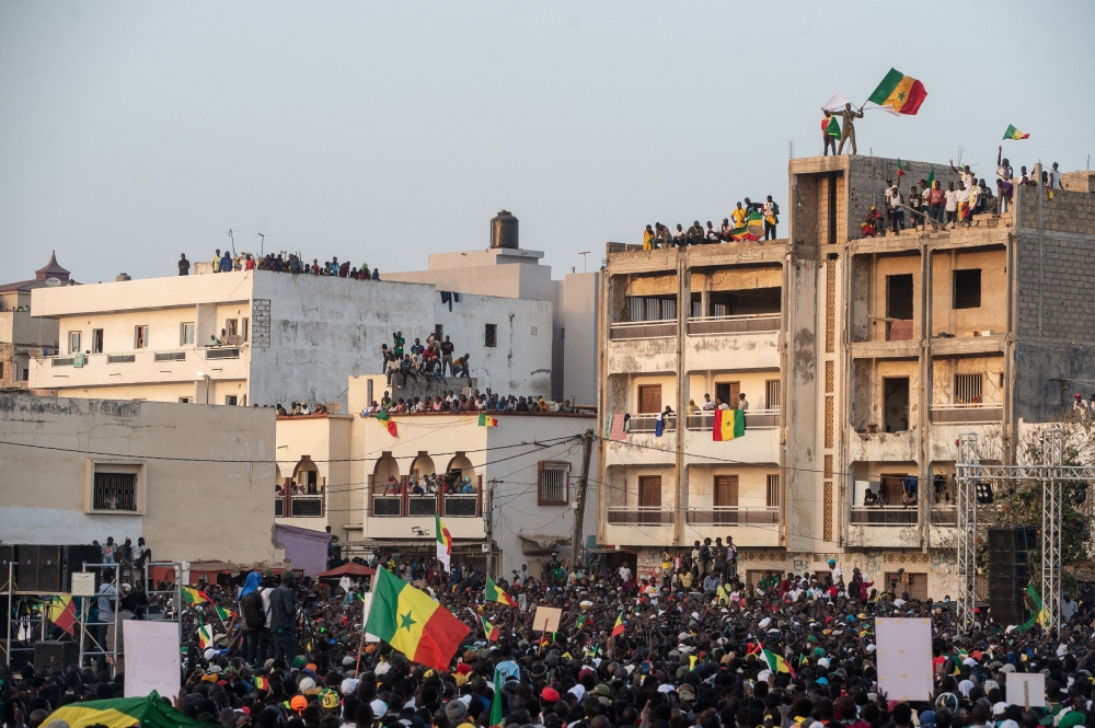 Opposition party supporters gather during an opposition meeting two days before Ousmane Sonko's trail in Dakar on March 14, 2023. (Photo by GUY PETERSON / AFP)
