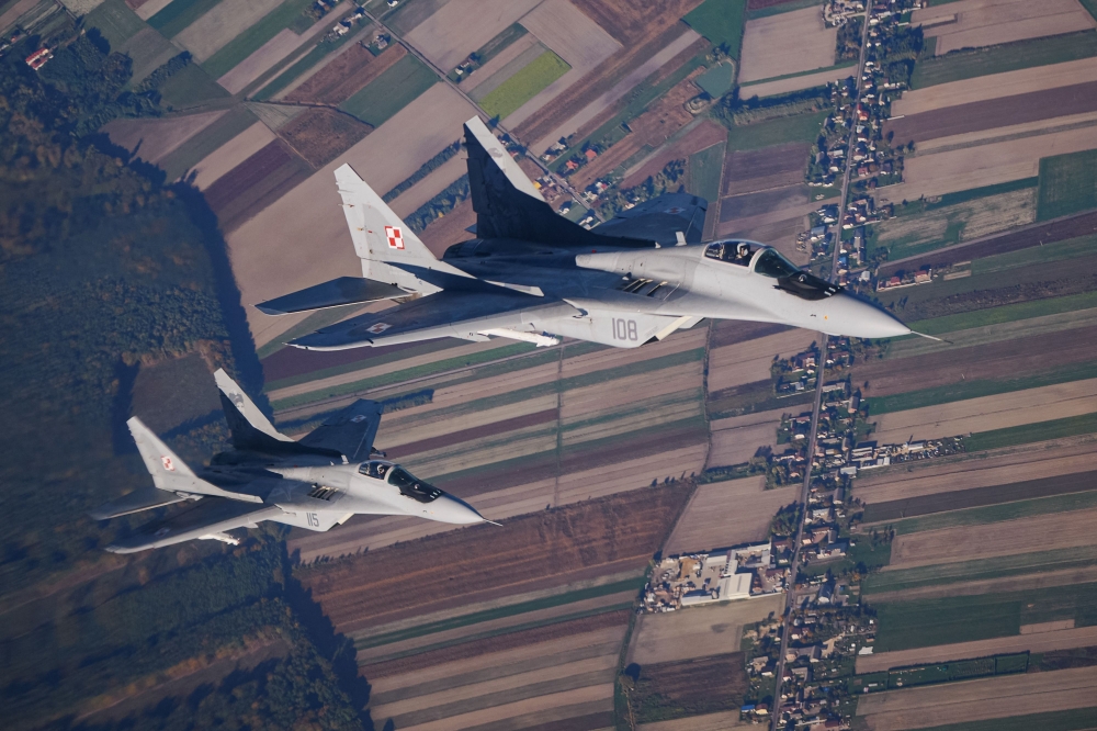 This file photo taken on October 12, 2022 shows two MiG 29 fighter jets taking part in the NATO Air Shielding exercise near the air base in Lask, central Poland. (Photo by RADOSLAW JOZWIAK / AFP)