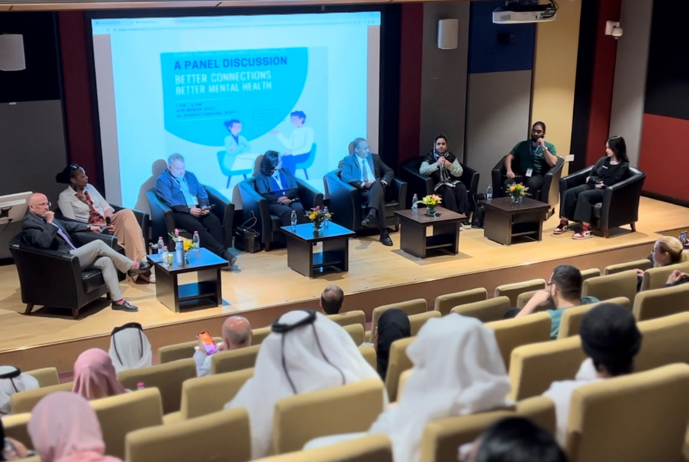 A general view of speakers and audience members during a panel session on mental health at UDST.