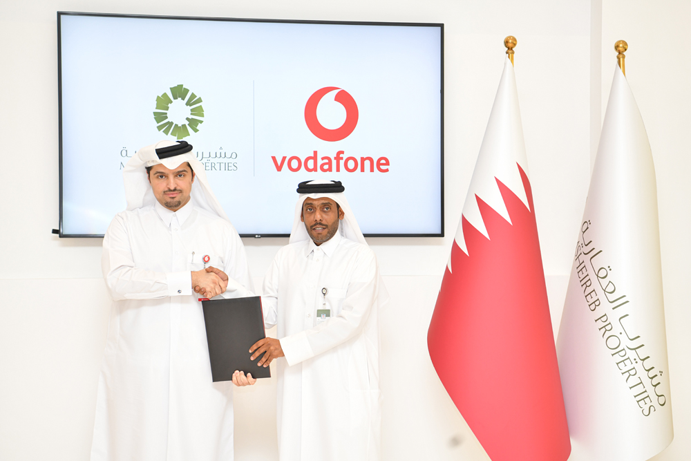 Vodafone Qatar and Msheireb Smart City officials exchange the agreement.