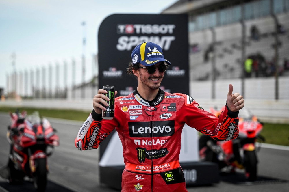 First-placed Ducati Italian rider Francesco Bagnaia poses for pictures after the sprint race of the MotoGP Portuguese Grand Prix at the Algarve International Circuit in Portimao, on March 25, 2023. (Photo by PATRICIA DE MELO MOREIRA / AFP)