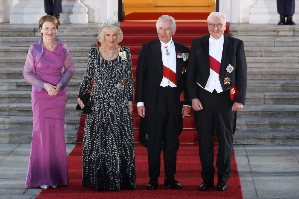 Britain's King Charles III (2nd R)and Britain's Camilla, Queen Consort (2nd L) are welcomed by German President Frank-Walter Steinmeier (R) and his wife Elke Buedenbender as they arrive for a state banquet at the presidential Bellevue Palace in Berlin, on March 29, 2023. (Photo by Ronny Hartmann / AFP)