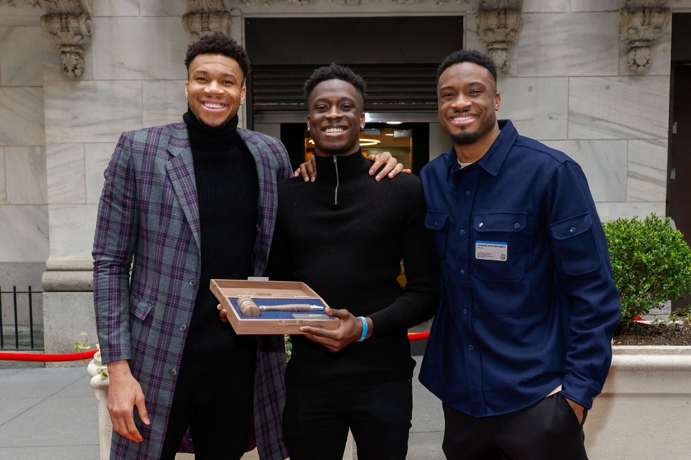 (Left to right) Professional basketball players Giannis Antetokounmpo, Alex Antetokounmpo, Thanasis Antetokounmpo pose for a photo before ringing the closing bell at New York Stock Exchange on March 31, 2023 in New York City. Mike Coppola/Getty Images/AFP