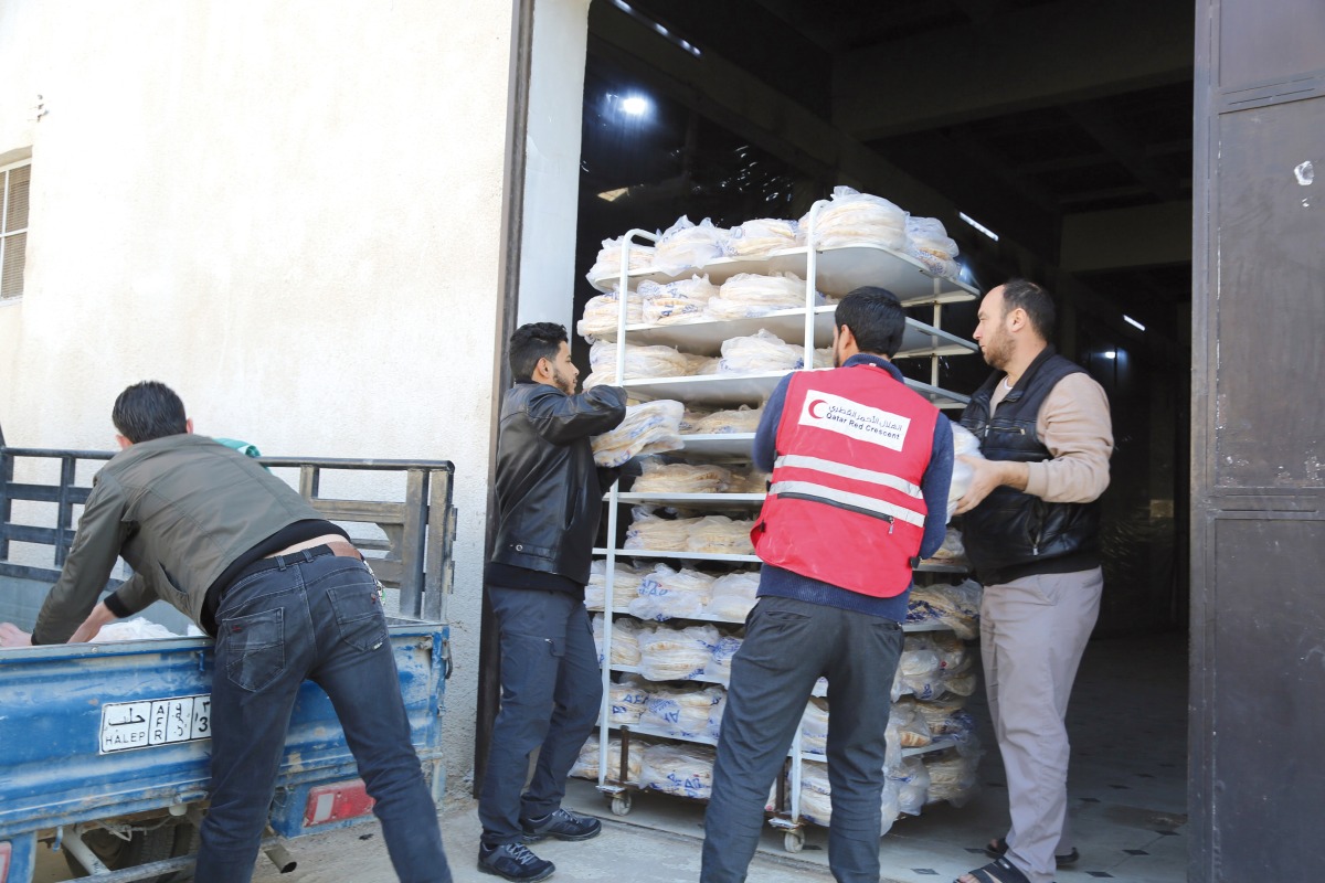 QRCS officials distribute food in Syria.