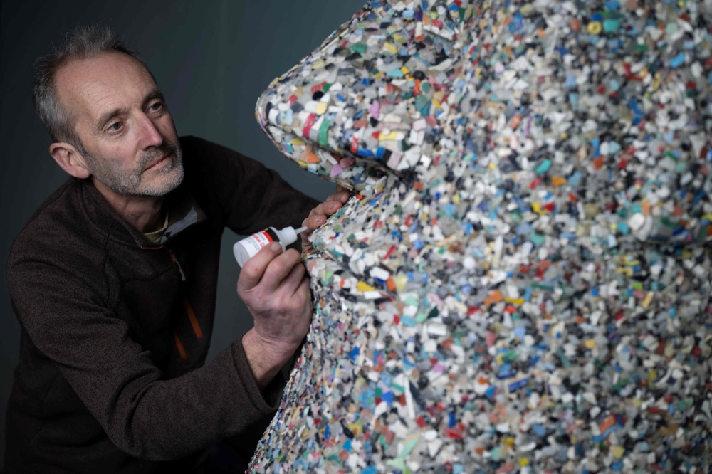 Artist and environmental activist Rob Arnold, works on a sculpture called 