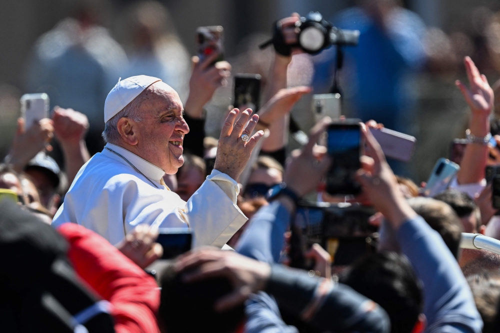 Pope Francis waves from the Popemobile car as he makes a tour of St. Peter's square following the Easter Sunday mass on April 9, 2023 in The Vatican. (Photo by Andreas Solaro / AFP)