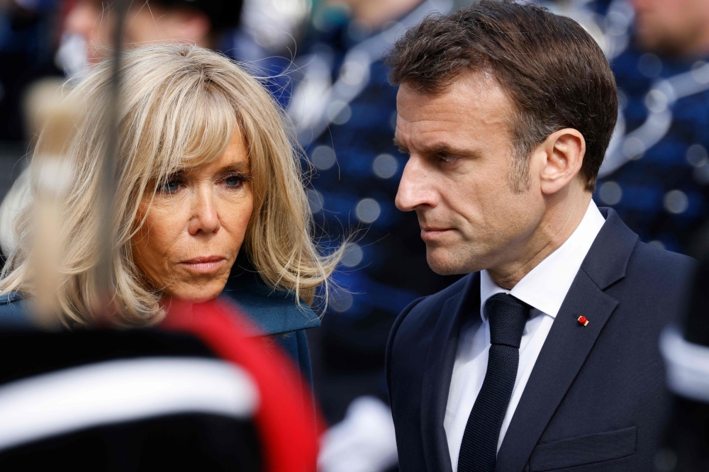 French President Emmanuel Macron and his wife Brigitte Macron are seen during a welcoming ceremony in The Hague on April 11, 2023 as part of a state visit to the Netherlands. (Photo by Ludovic Marin / AFP)