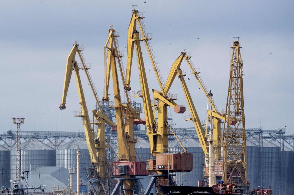 A photo taken on April 10, 2023 shows cranes at the grain terminal of the port of Odessa, Ukraine, from where Ukraine ships wheat according to the grain agreement the country currently has with Russia. (Photo by Bo Amstrup / Ritzau Scanpix / AFP)