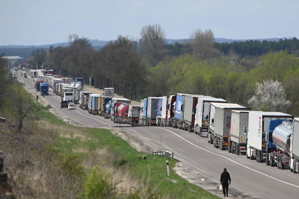 Truck drivers queue on over ten kilometers at the Rava-Ruska border checkpoint on the Ukrainian-Polish border, on April 18, 2023. Photo by YURIY DYACHYSHYN / AFP