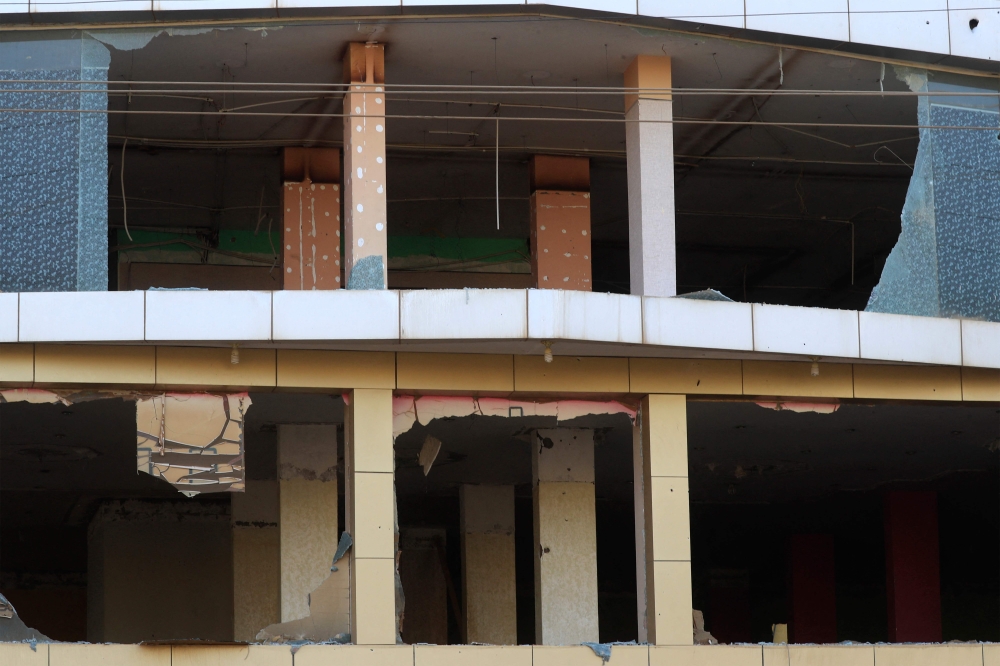 Windows are broken on the facade of a commercial building along the main al-Sittin (sixty) road in eastern Khartoum on April 21, 2023 amidst ongoing battles between the forces of two rival Sudanese generals. (Photo by AFP)