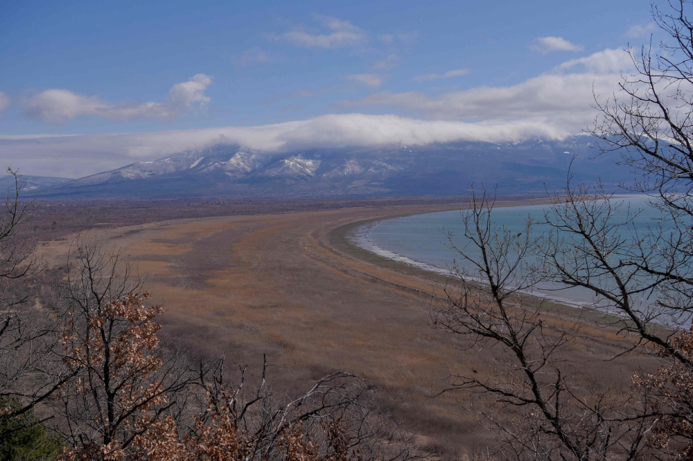 This photograph taken on March 17, 2023, shows a general view of the Prespa lake near Otesevo, in North Macedonia. (Photo by Armend NIMANI / AFP)