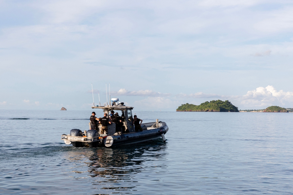 French gendarmes of the nautical brigade operate on the Mukombe boat, preparing for an operation against illegal migration in French territorial seas on the island of Mayotte, on April 24, 2023. (Photo by Morgan Fache / AFP)
