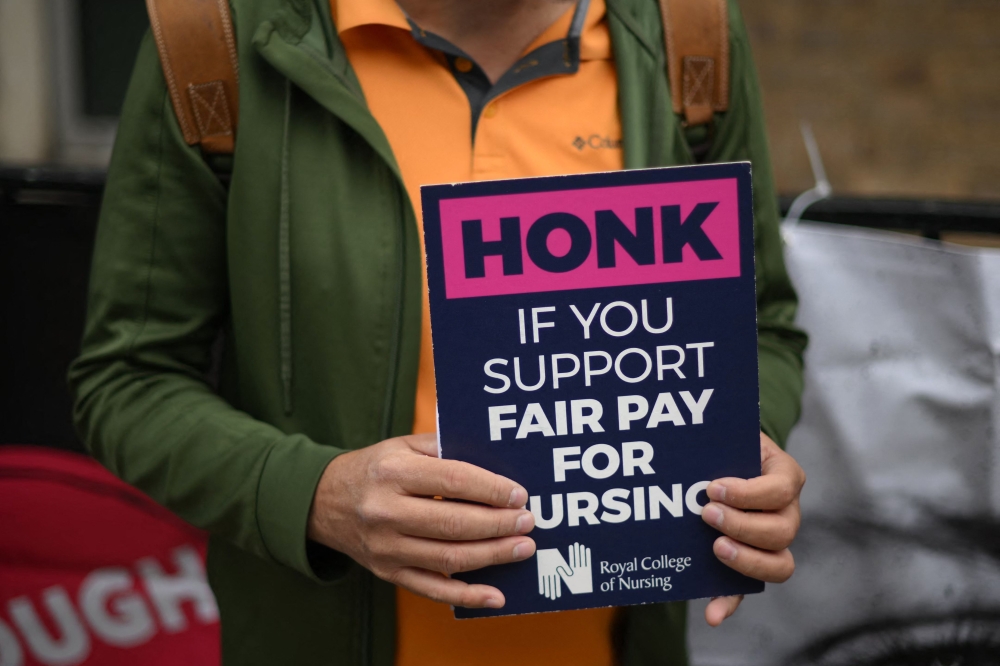 Members of the Royal College of Nursing (RCN) union man a picket line outside Great Ormond Street Hospital for Children in London on May 1, 2023. (Photo by Daniel LEAL / AFP)