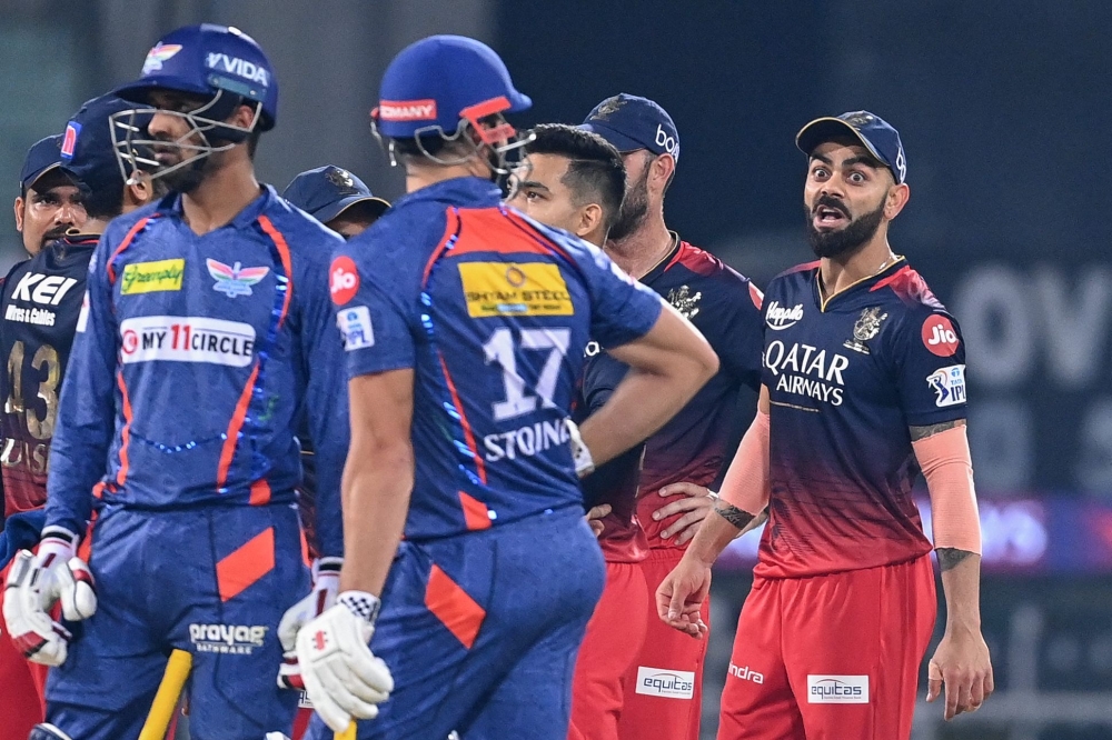 Royal Challengers Bangalore's Virat Kohli (R) gestures during the Indian Premier League (IPL) Twenty20 cricket match between Lucknow Super Giants and Royal Challengers Bangalore on May 1, 2023. (Photo by Sajjad Hussain / AFP)