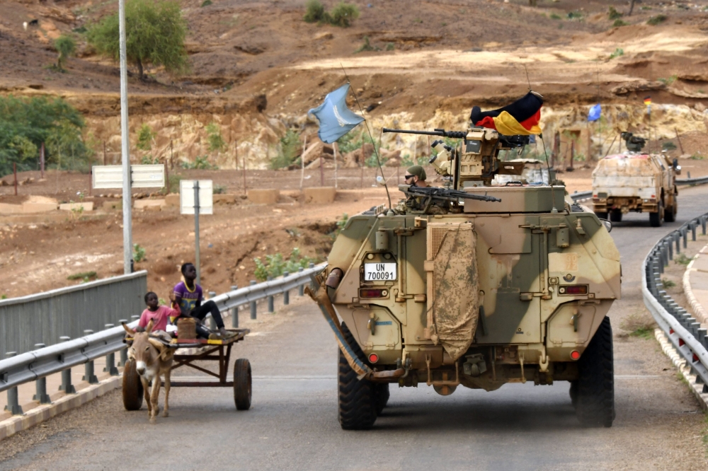 In this file photo taken on August 03, 2018 Germans soldiers from the parachutists detachment of the MINUSMA (United Nations Multidimensional Integrated Stabilization Mission in Mali) cross the Niger river bridge during a patrol searching for IED (improvised explosive device) on the route from Gao to Gossi, Mali. (Photo by SEYLLOU / AFP)
