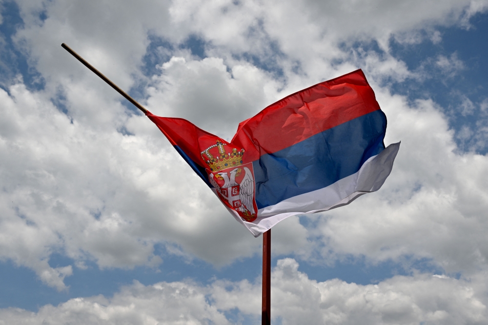 This photograph shows the Serbian flag at half mast in the village of Malo Orasje near the town of Mladenovac, about 60 kilometres (37 miles) south of Serbia's capital Belgrade, on May 6, 2023, in the aftermath of a drive-by shooting. (Photo by Andrej Isakovic / AFP)