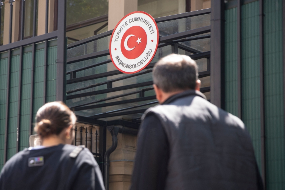 Turkish citizens are seen in front of the Turkish consulate in Vienna, Austria on the last day of the presidential elections, on May 9, 2023. (Photo by Alex Halada / AFP)