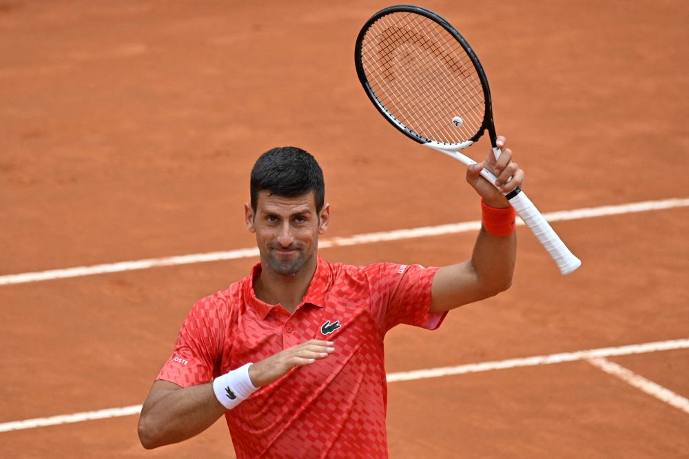 Serbia's Novak Djokovic acknowledges the public after defeating Britain's Cameron Norrie in their fourth round match of the Men's ATP Rome Open tennis tournament at Foro Italico in Rome on May 16, 2023. (Photo by Tiziana Fabi / AFP)