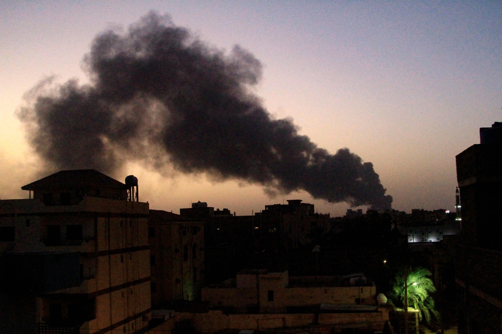 Smoke rises above buildings in southern Khartoum on May 19, 2023, as violence between two rival Sudanese generals continues. (Photo by AFP)