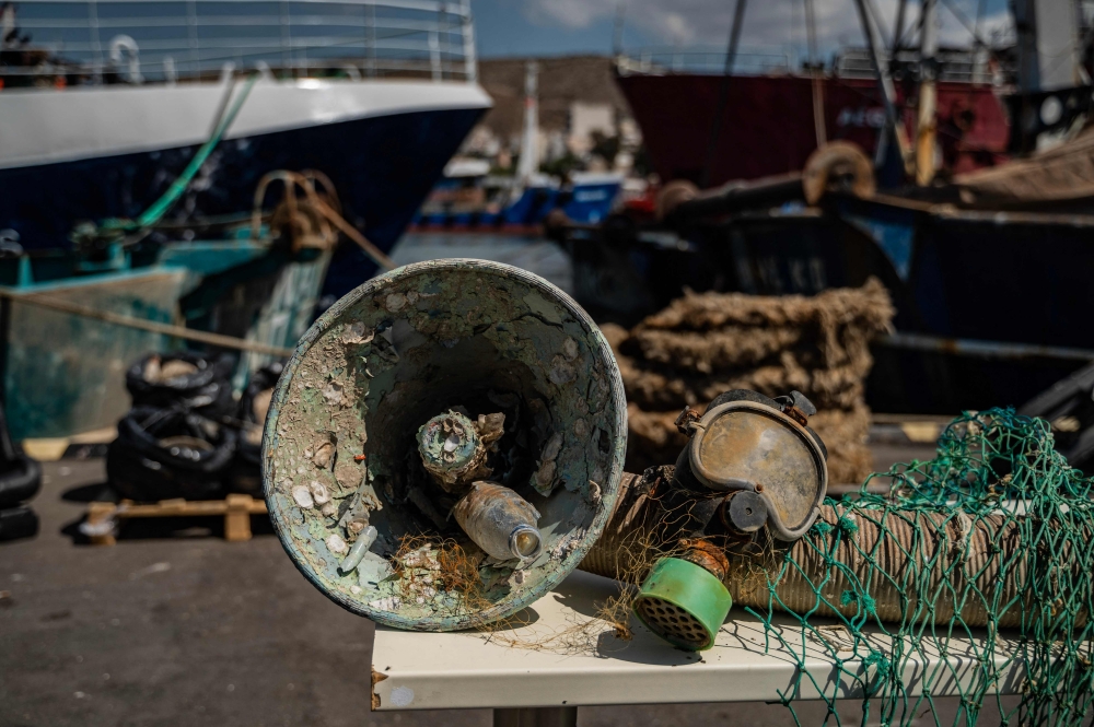 This picture shows marine litter that divers and fishermen collected, at Keratsini's sea food market, in Keratsini, on May 26, 2023. (Photo by Angelos Tzortzinis / AFP)