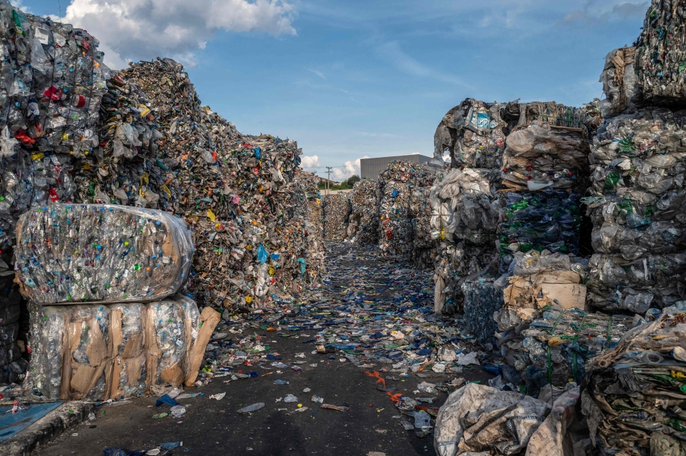 This picture shows plastic bottles at a Recycle Factory in the city of Megara near Athens, on May 26, 2023. (Photo by Angelos Tzortzinis / AFP)