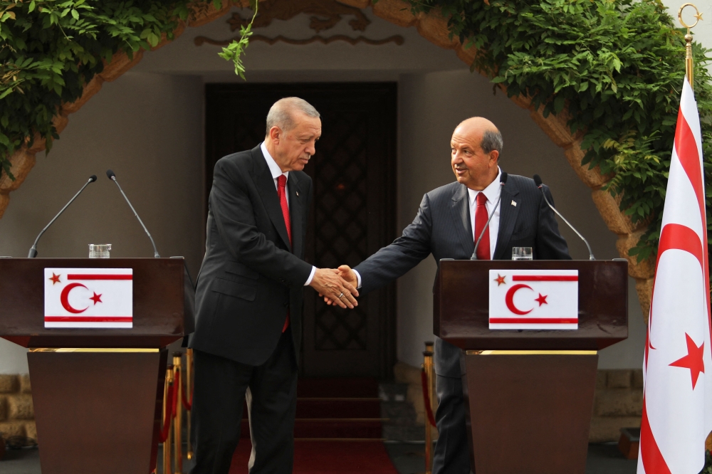 Turkish President Recep Tayyip Erdogan (left) shakes hands with the leader of the self-proclaimed Turkish Republic of Northern Cyprus, Ersin Tatar, during an official visit in Nicosia, on June 12, 2023. (Photo by Birol Bebek / AFP)