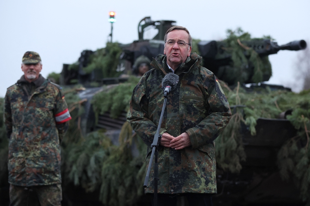 (FILES) German Defence Minister Boris Pistorius stands in front of a Puma tank as he addresses troops of the German armed forces Bundeswehr at a military training area in Altengrabow near Moeckern, eastern Germany, on January 26, 2023. (HARTMANN / AFP)

