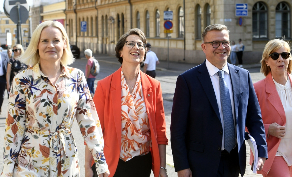 The Finns Party chair Riikka Purra (left), Christian Democrats chair Sari Essayah, National Coalition Party chair PM-designate Petteri Orpo and Swedish People's Party chair Anna-Maja Henriksson arrive to a press conference on details of the governing agenda regarding of the four-party cabinet in Helsinki, Finland, on June 16, 2023. (Photo by Kimmo Penttinen / Lehtikuva / AFP)